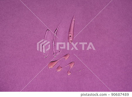 Smears of transparent liquid cosmetics on a purple background 90687489