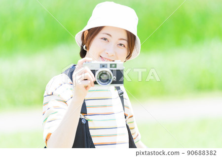 Woman with a camera in the park Woman with a camera in the park 90688382