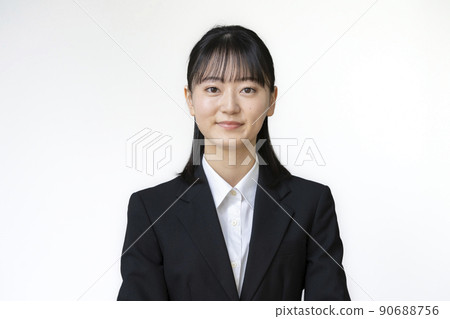 A young woman in a suit looking at the camera Portrait 90688756