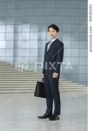 A young man in a suit looking at the camera portrait A young man in a suit looking at the camera portrait 90689202