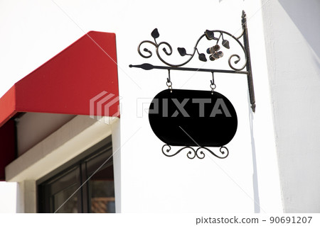 Red awning and iron sign 90691207