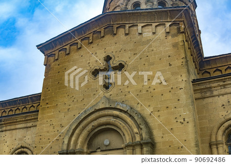 traces of bullets and shrapnel on the wall of an old Christian church 90692486