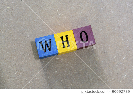 WHO acronym on colorful wooden cubes against wooden background. WHO acronym on colorful wooden cubes against wooden background. 90692789