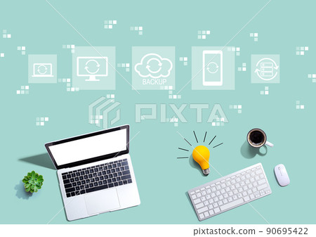 Backup concept with computers with a light bulb Backup concept with computers with a light bulb 90695422