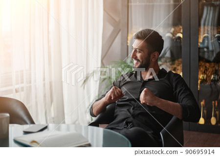 happy wine business owner sitting in front of an open notebook. 90695914