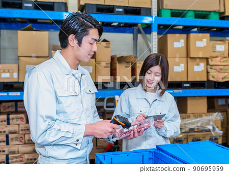 Workers checking inventory in the warehouse Workers checking inventory in the warehouse 90695959
