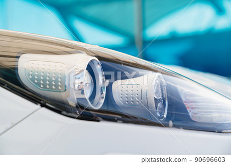 headlight of a clean white machine. self-service car wash. car washer. 90696603