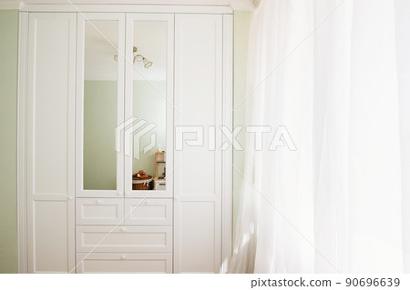 White built-in wardrobe with mirrors. storage and order in the apartment. White built-in wardrobe with mirrors. storage and order in the apartment. 90696639