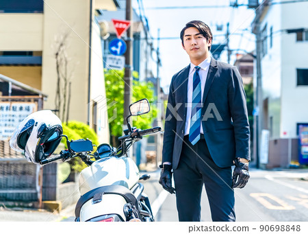 Office worker commuting by motorcycle Tokyo 90698848