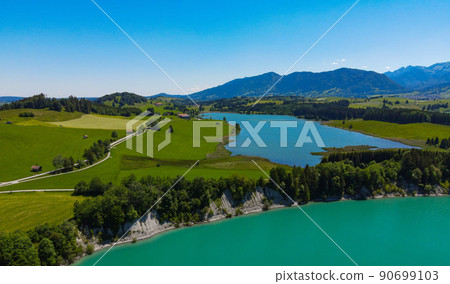 Aerial view over Lake Forggensee at the city of Fuessen in Germany Aerial view over Lake Forggensee at the city of Fuessen in Germany 90699103
