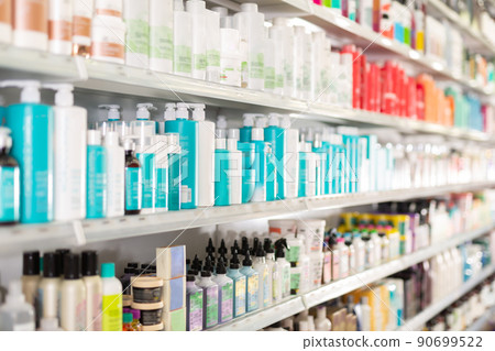 Hair care products on store shelves in supermarket 90699522