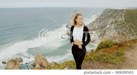 Beautiful woman relaxes at Cabo da Roca in Portugal - Sintra Natural Park 90699565
