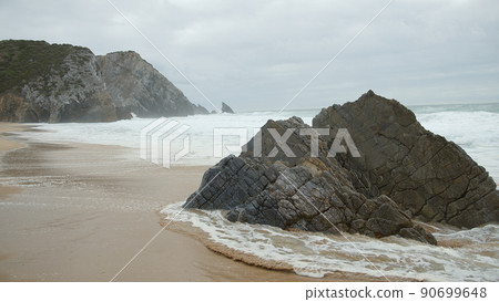 Wild Atlantic ocean coast at Adraga Beach in Portugal 90699648