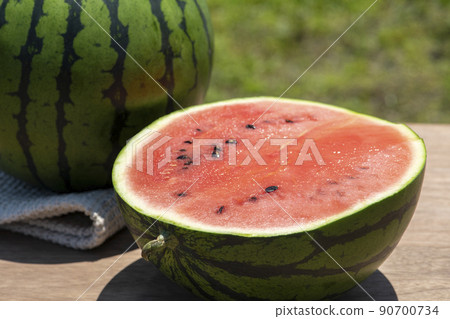 Cut freshly picked watermelons harvested in summer outdoor fields 90700734