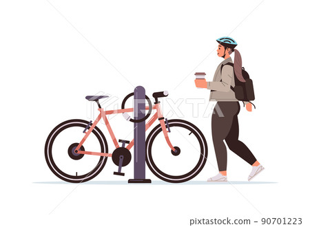female cyclist taking break during bike ride woman in helmet with takeaway coffee cup standing near bicycle female cyclist taking break during bike ride woman in helmet with takeaway coffee cup standing near bicycle 90701223