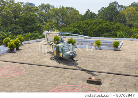 Ho Chi Minh, Vietnam - Oct 17, 2019 : old US Vietnam War helicopter UH-1 upon the roof of Independence Palace (Reunification Palace) in Ho Chi Minh City, Vietnam on Oct 17, 2019. 90702947