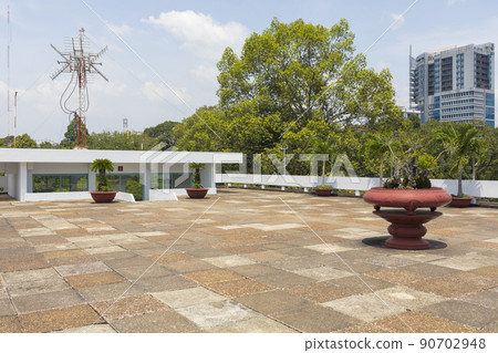 Ho Chi Minh, Vietnam - Oct 17, 2019 : old US Vietnam War helicopter UH-1 upon the roof of Independence Palace (Reunification Palace) in Ho Chi Minh City, Vietnam on Oct 17, 2019. 90702948