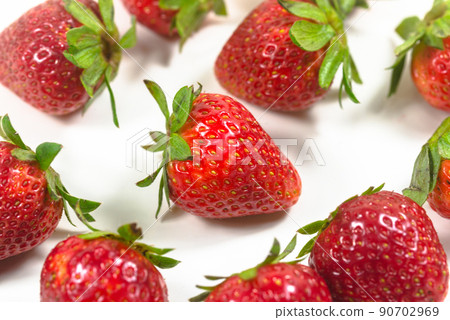 Few strawberries on a white background 90702969