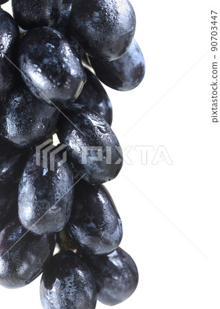 Bunch of black raisins or grapes isolated on white background 90703447