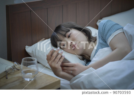 Female smartphone before going to bed Female smartphone before going to bed 90703593