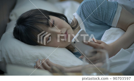 Female smartphone before going to bed 90703597