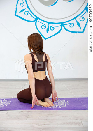 One girl in sitting pose on the floor doing yoga meditation 90703629