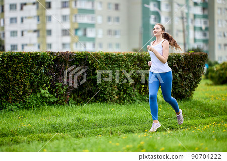 Health running in city in summer by woman in leggins. Health running in city in summer by woman in leggins. 90704222