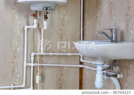 Tank style water heater, using electricity to heat water for home water supply. Tank style water heater, using electricity to heat water for home water supply. 90704223