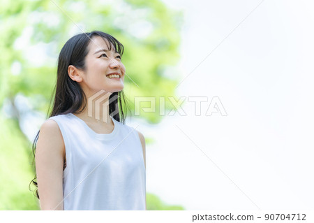 Woman in the fresh green (smile) 90704712