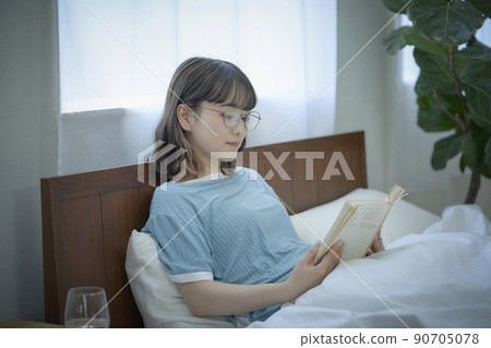 A woman reading in bed A woman reading in bed 90705078