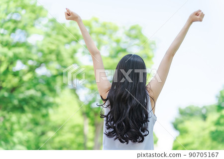 A woman taking a deep breath in the fresh green (without face) 90705167