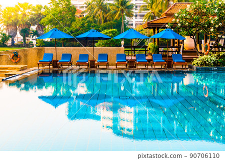Beautiful umbrella and chair around swimming pool in hotel and resort Beautiful umbrella and chair around swimming pool in hotel and resort 90706110