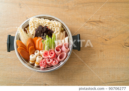 Budae Jjigae or Budaejjigae (Army stew or Army base stew). It is loaded with Kimchi, spam, sausages, ramen noodles and much more Budae Jjigae or Budaejjigae (Army stew or Army base stew). It is loaded with Kimchi, spam, sausages, ramen noodles and much more 90706277