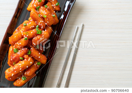 deep fried Korean rice cake (Tteokbokki) skewered with spicy sauce 90706640