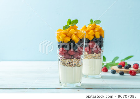 homemade mango, raspberry and blueberry with yogurt and granola 90707085