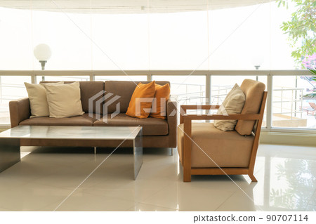 empty sofa and chair with pillows 90707114