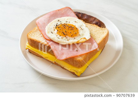 bread toasted cheese topped ham and fried egg with pork sausage 90707639