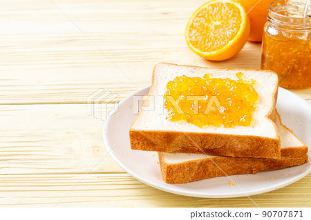 Slices of bread with orange jam Slices of bread with orange jam 90707871