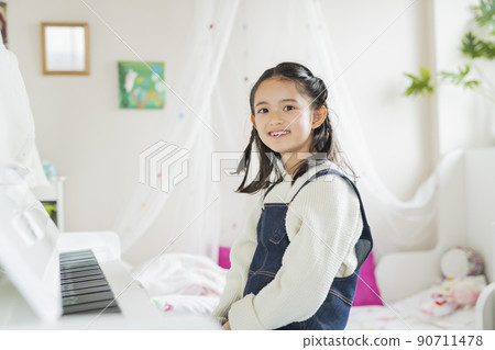 Girl playing the piano in the room Girl playing the piano in the room 90711478