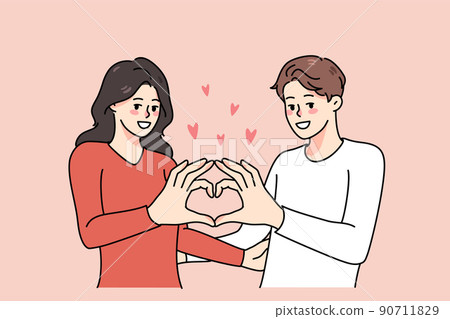 Happy couple show heart hand gesture  90711829