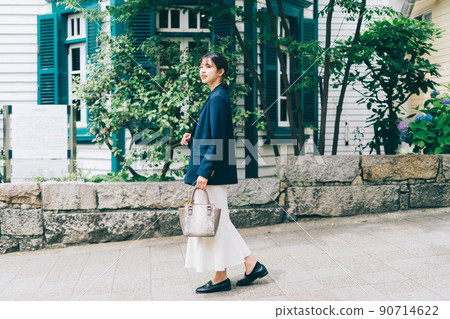 A young lady walking in the city A young lady walking in the city 90714622