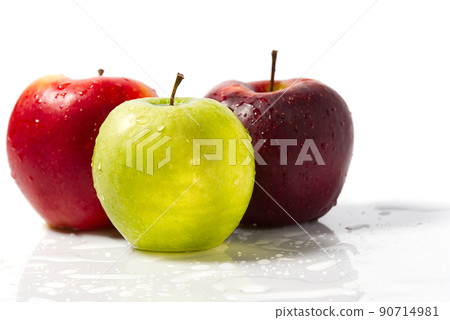 Three apples with water drops. Delicious appetizing beautiful fresh green and red apples on a white background. Three apples with water drops. Delicious appetizing beautiful fresh green and red apples on a white background. 90714981
