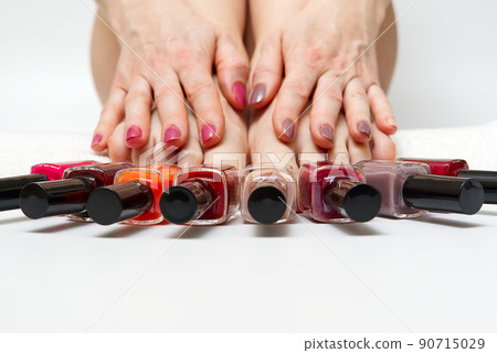 Woman at home spa doing pedicure to herself in white background, close-up. Woman at home spa doing pedicure to herself in white background, close-up. 90715029