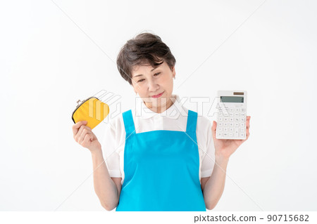 A woman in an apron worries about money calculator 90715682