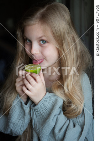 Beautiful little girl with lime 90717959