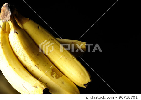 Take a bunch of bananas on a black background Take a bunch of bananas on a black background 90718701