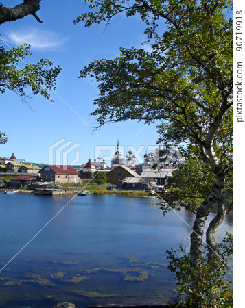 View from the shore of the White Sea to the Spaso-Preobrazhensky Solovetsky Monastery on a summer day framed by birch trees. Solovetsky Island. Arkhangelsk region. Russia 90719918