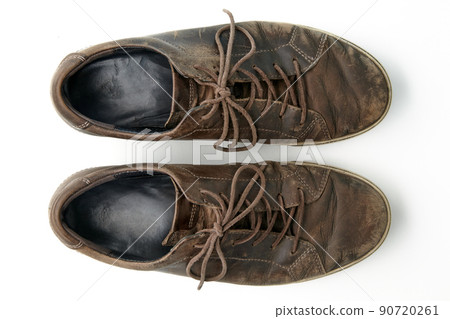Worn vintage brown leather boots isolated on white background 90720261