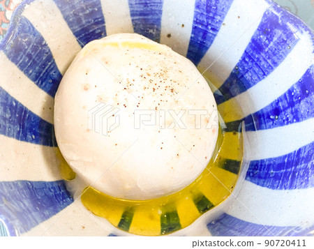 Burrata cheese with salt and pepper and lemon olive oil 90720411