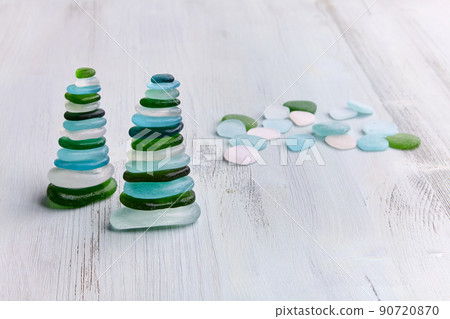 Two zen pyramids on a beach wooden sun bed Two zen pyramids on a beach wooden sun bed 90720870